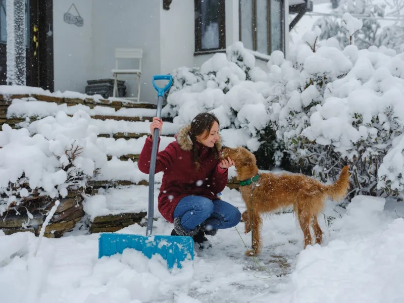 Woman clearing the driveway after the blizzard