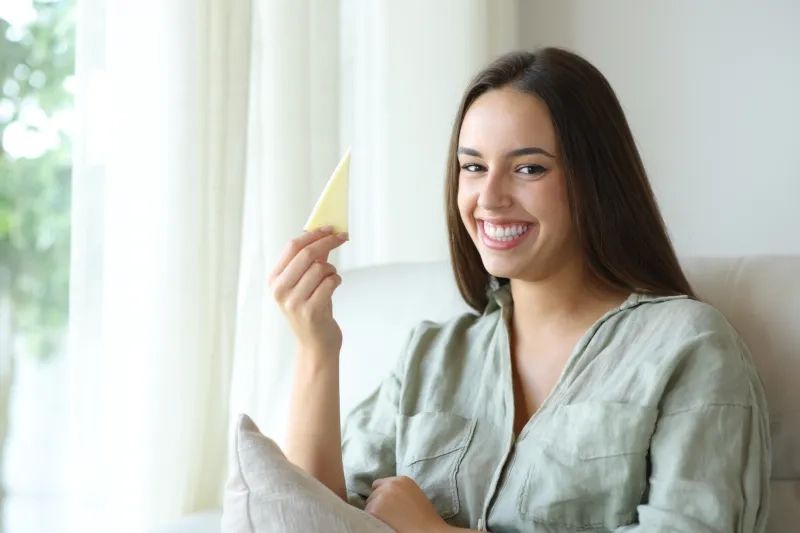 Woman with a slice of cheese