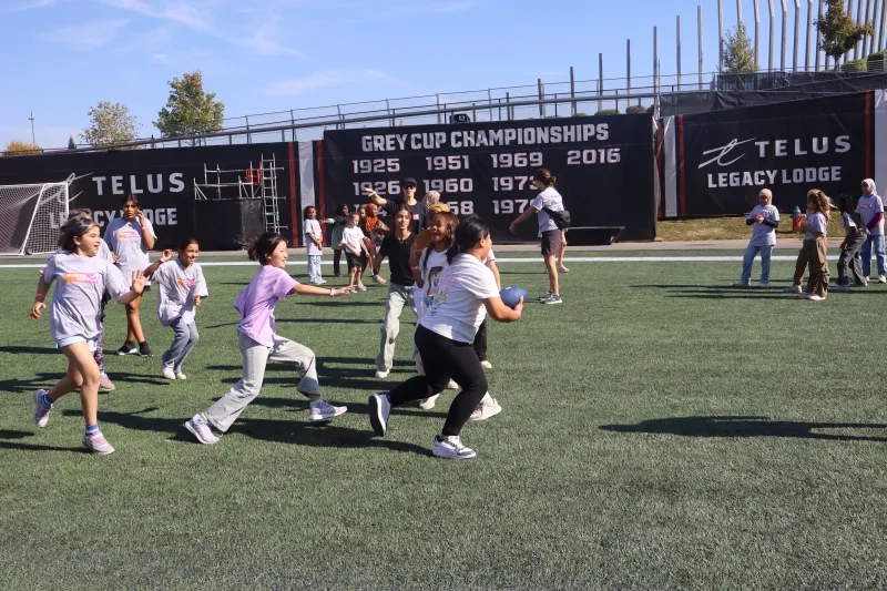 GIrls enjoy learning football skills on the field at TD Place