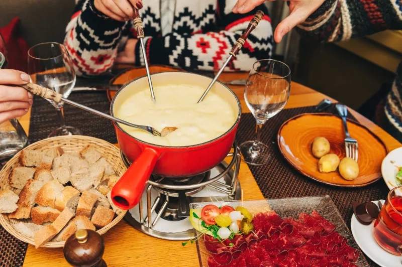 friends eating cheese fondue