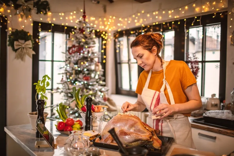 Woman preparing a turkey dinner