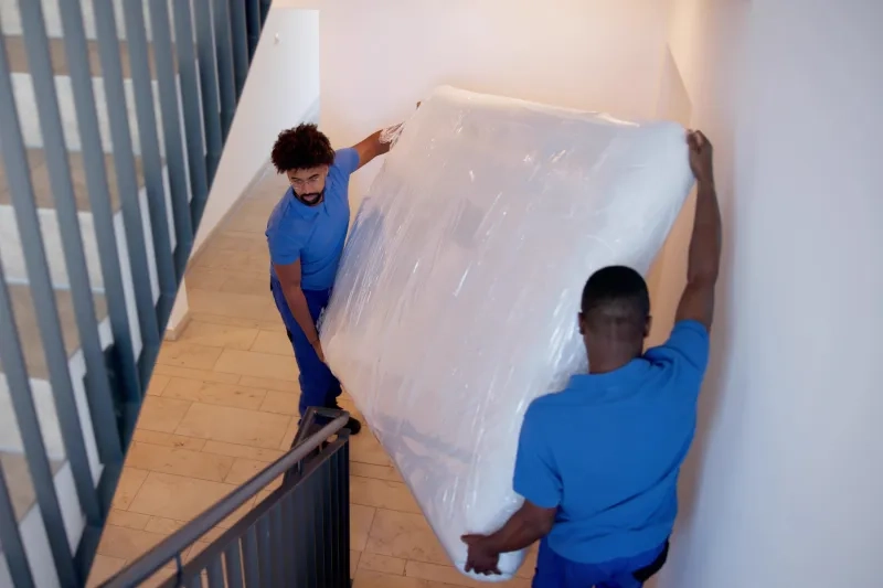 Movers lifting a mattress