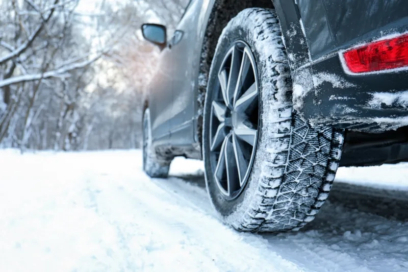 Winter Car Tire on Snowy Road