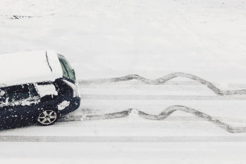 A car skids on snow and ice covered road