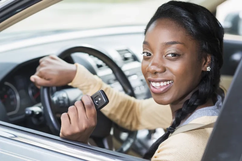 woman in car holding car keys