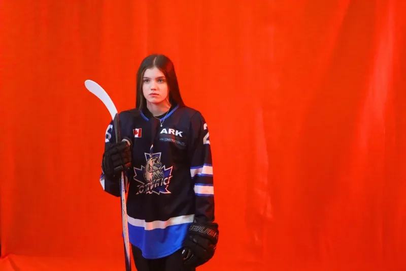 A young teen girl poses with her hockey jersey and stick in a promo video for Sens Skills jr draft