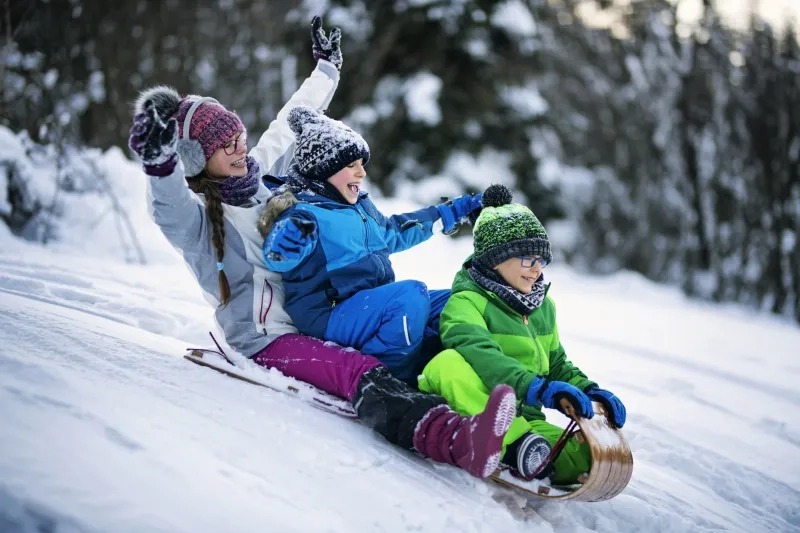Children tobogganing in winter
