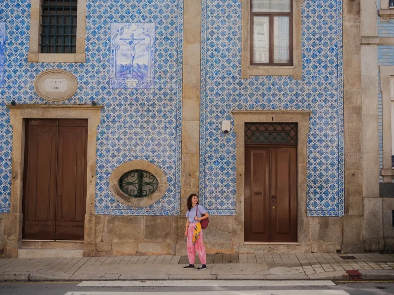 Woman standing in front of blue chapel