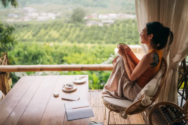 woman drinking coffee looking outdoors