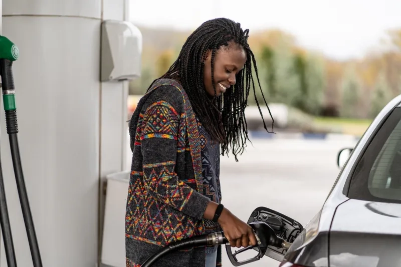 woman at fuel station refueling her car