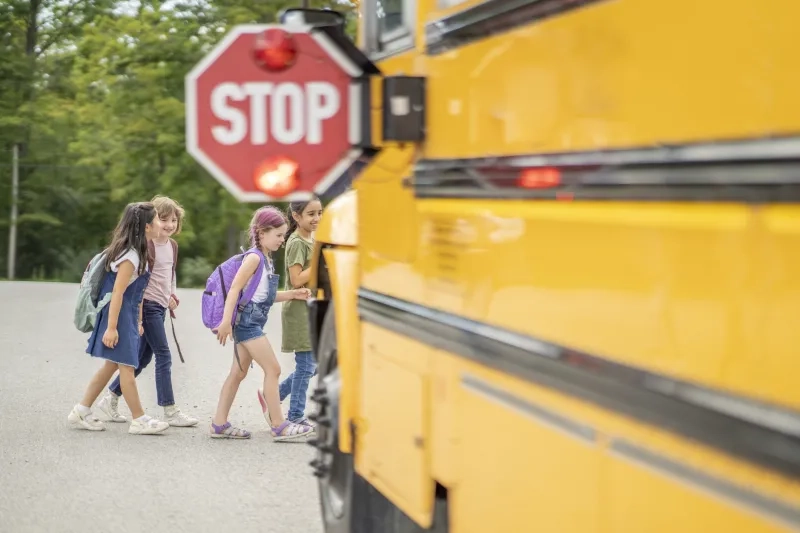 Children crossing to board school bus
