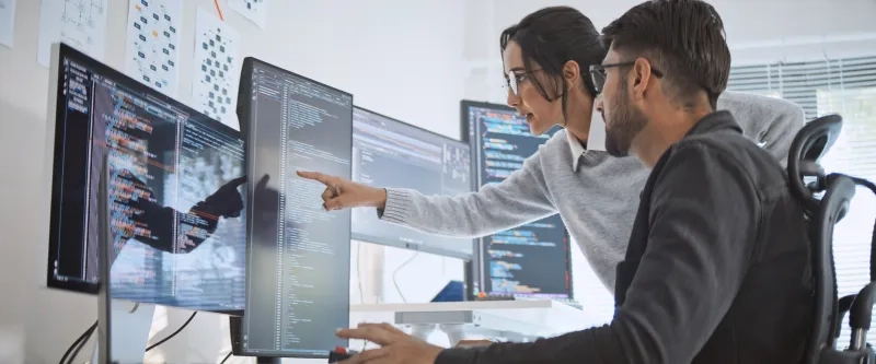 two people looking at a computer