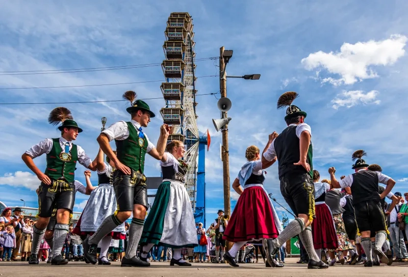 a group of typical bavarian dancers with traditional clothing at the Oktoberfest in Munich