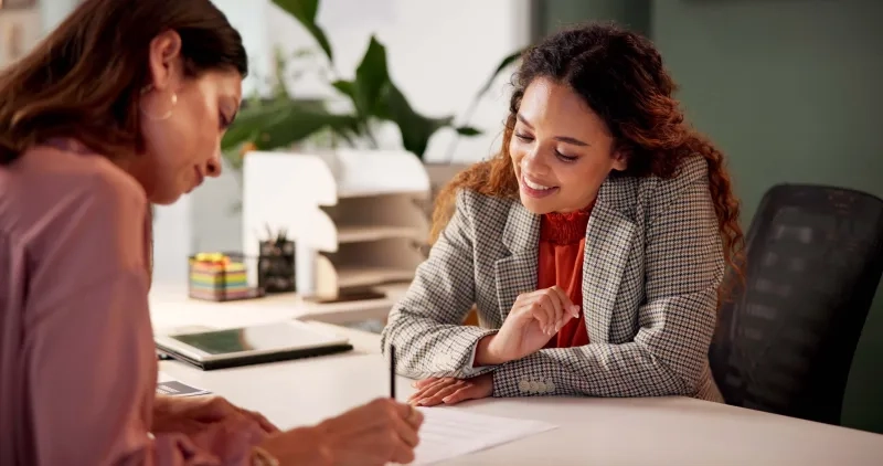 woman signing insurance paperwork