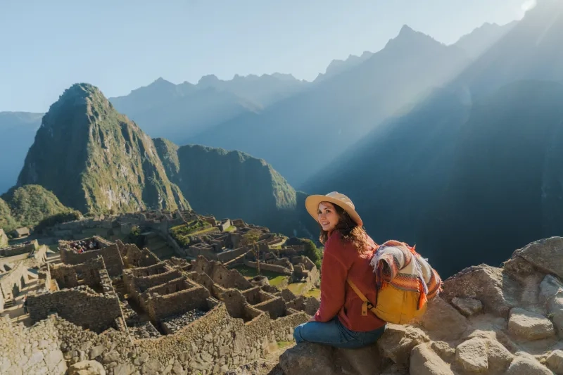 Woman exploring Machu Picchu during trip to Peru