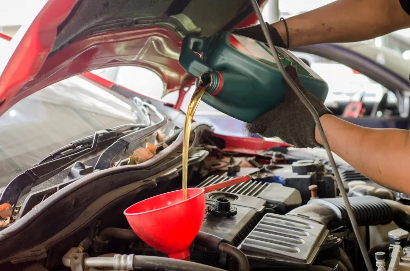 Hands Pouring Engine Oil