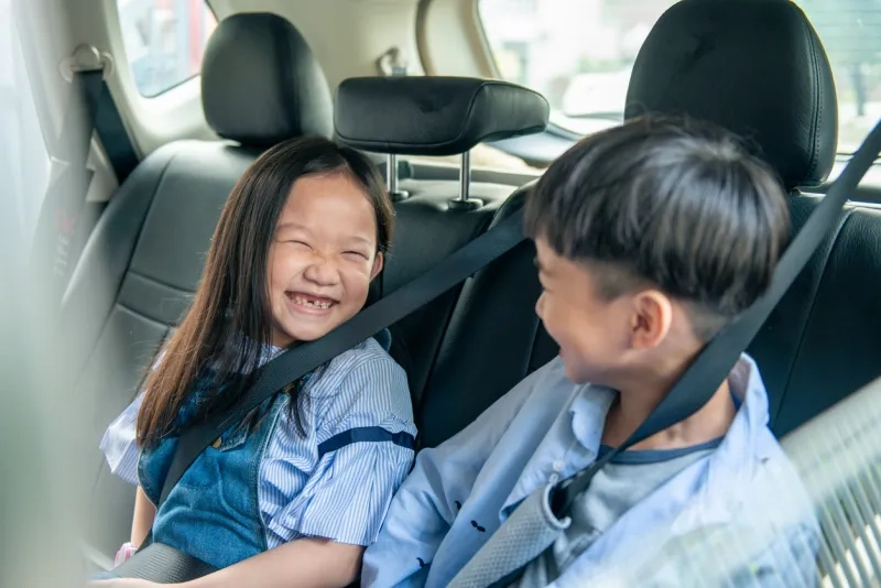 Two children in the back seat of a car