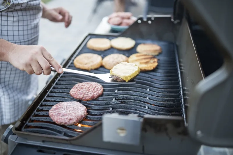 Preparing burgers at a garden party