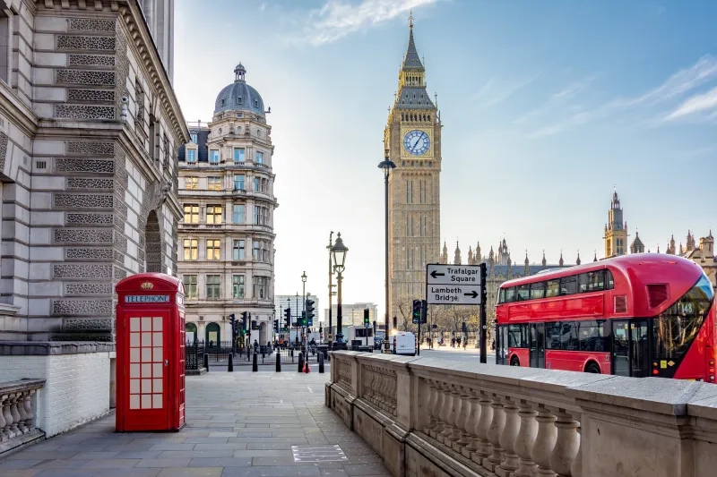 Red telephone box and double-decker bus on Parliament square and Big Ben tower