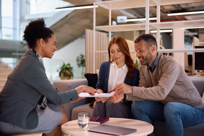 Couple looking over paperwork to purchase a home