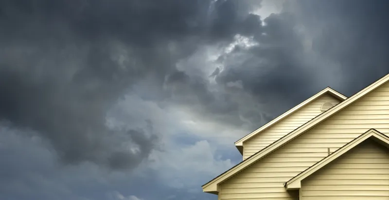 House roof with stormy skies
