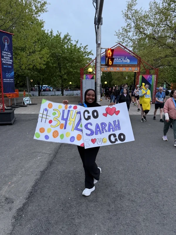 Sarah Hirsi holding sign supporters made for her