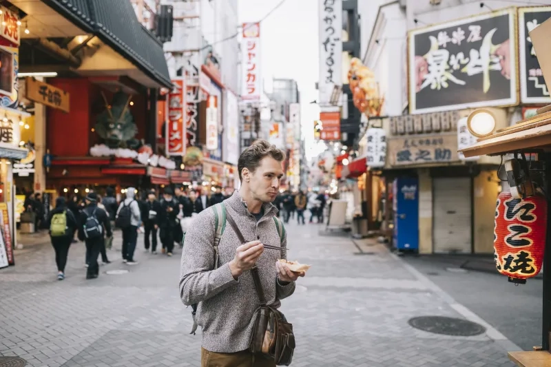Tourist eating takoyaki