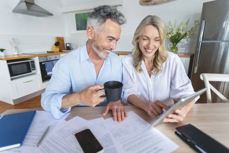 Mature couple doing paperwork at home