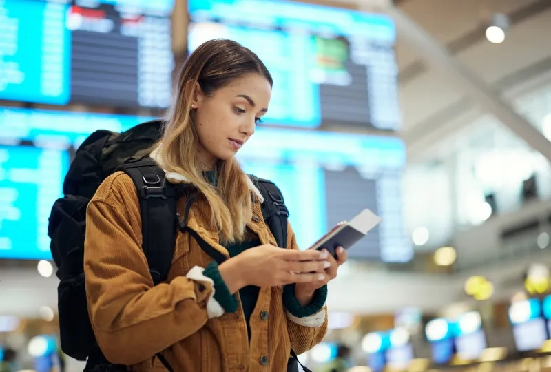 Woman holding passport at airport