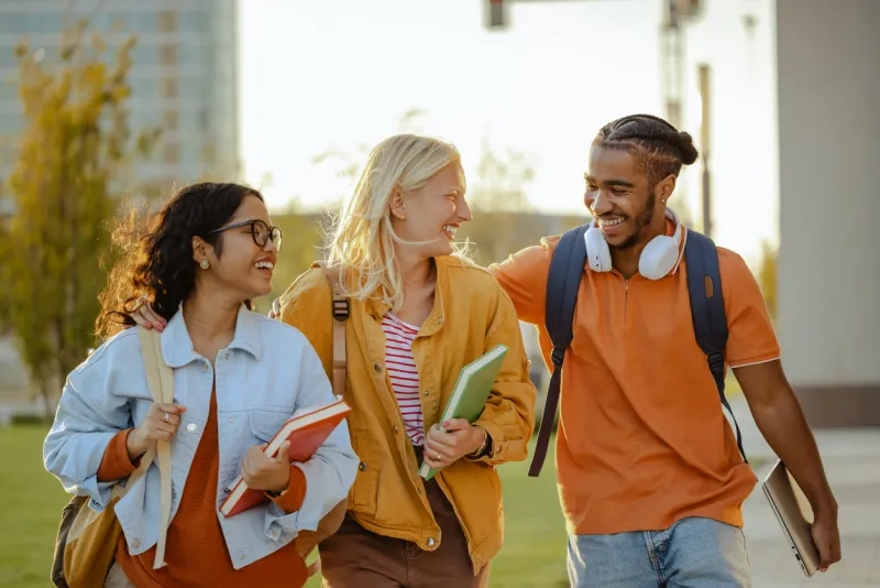 Three university students walking together between classes