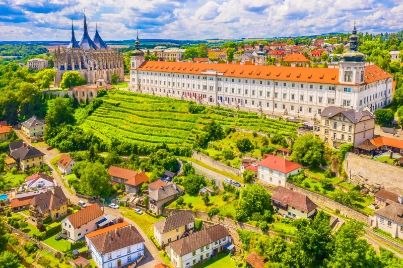 A stunning view of the historic castles and landscape of Kutna Hora, Czech Republic, showcasing medieval architecture surrounded by lush greenery