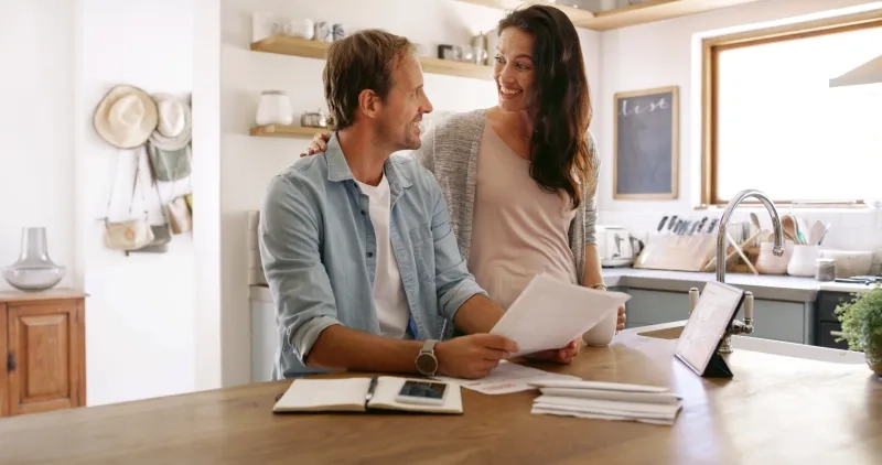 couple looking at paperwork in kitchen