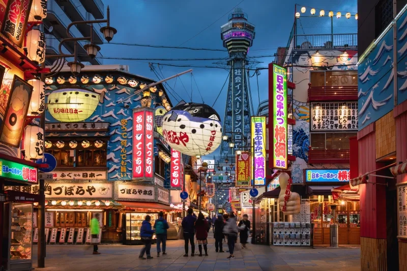 Downtown Osaka Shinsekai at Twilight. Crowd of People enjoying the vibrant atmosphere of the Shinsekai District at dusk, 