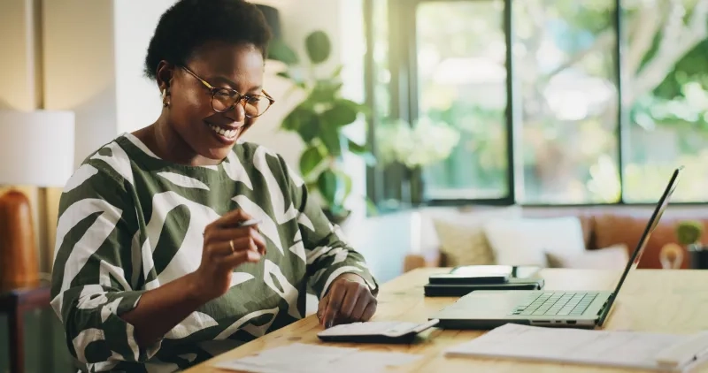 Woman reviewing finances with laptop