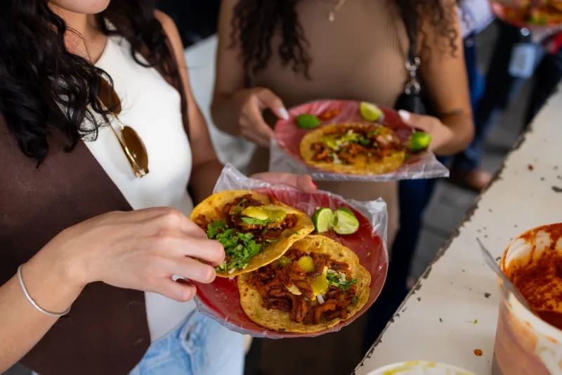 Two women eating tacos