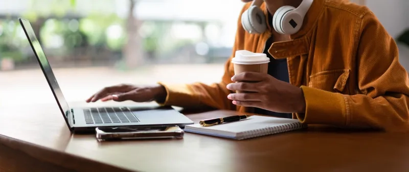 man working on laptop with coffee