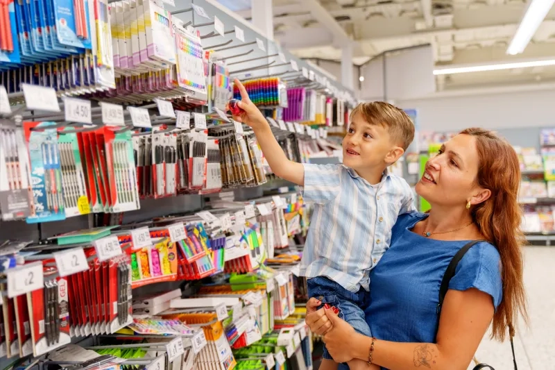 Mom and young son picking school supplies.