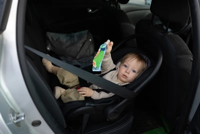 Baby with snack in car