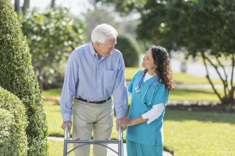 Female nurse helping senior man