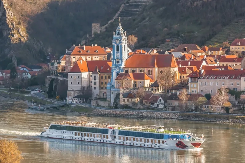 Durnstein village with tourist ship on Danube river in Wachau 