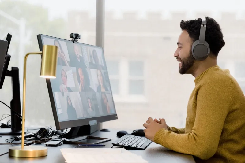 Man participates in a video conference with colleagues.