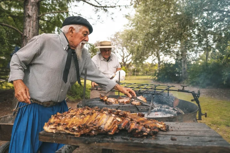 Men preparing a rib barbecue in the firewood