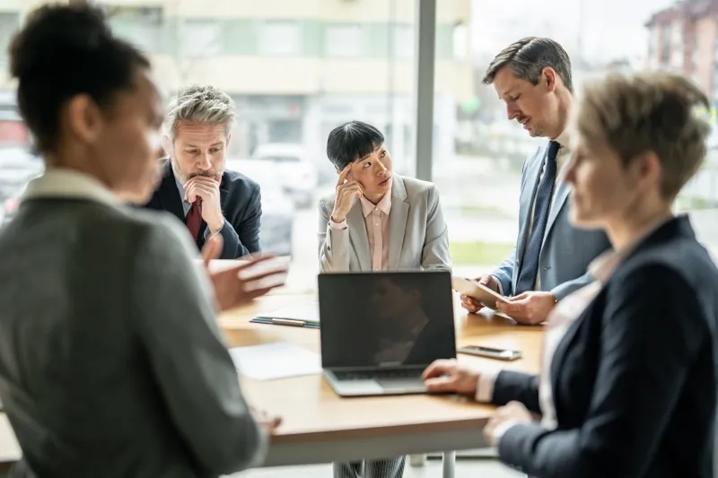 Multi-ethnic businesspeople brainstorming new ideas and collaborating in conference room