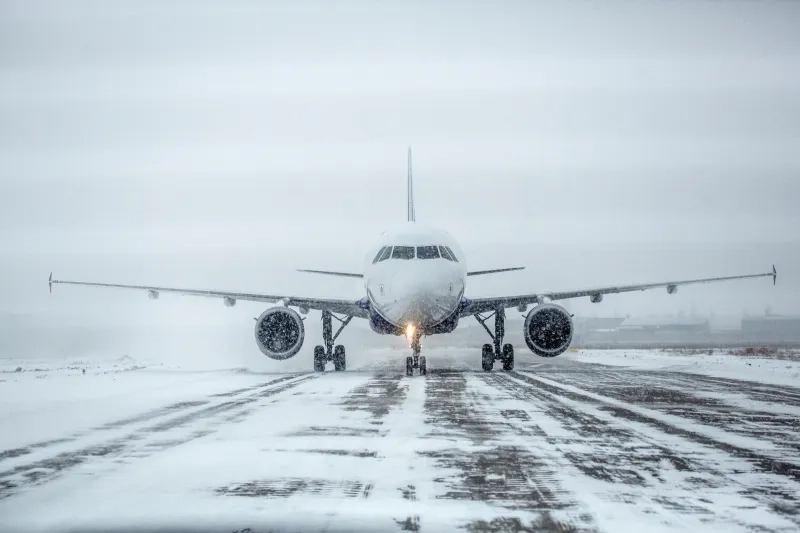 Airplane on runway covered with snow