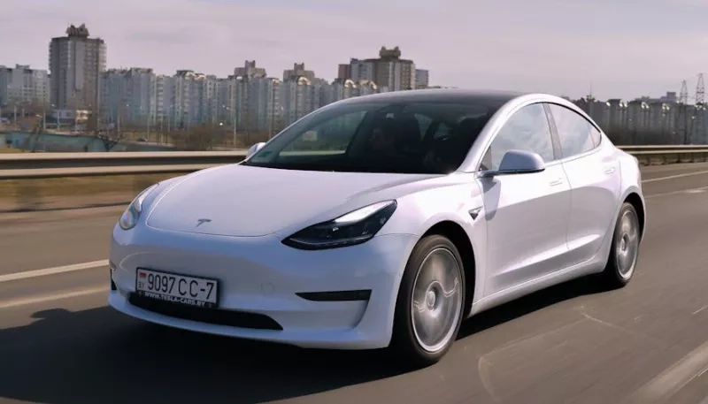 A tesla model 3 being driven