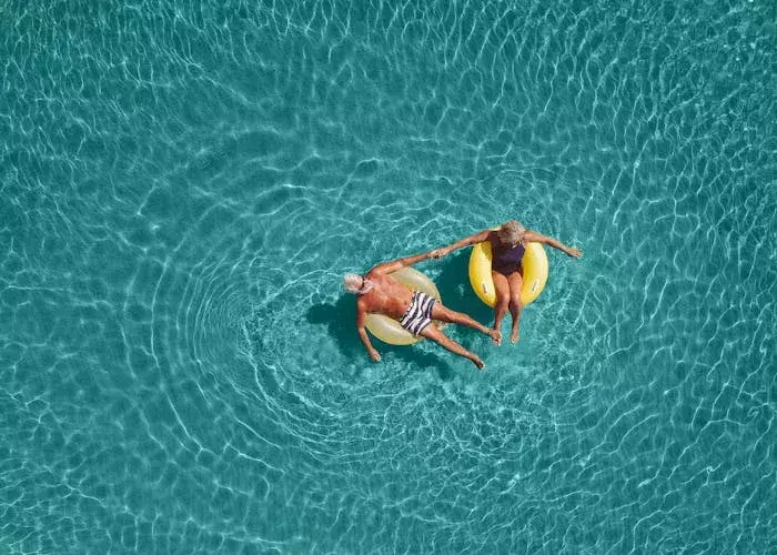 Senior couple floating in the water