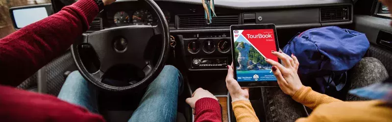 Woman viewing an Ontario TourBook on her tablet 