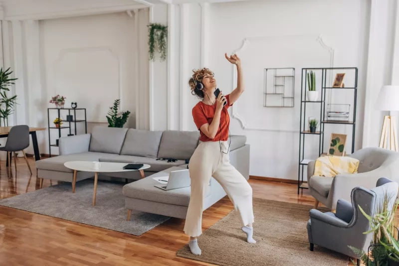 Woman listening to music in apartment