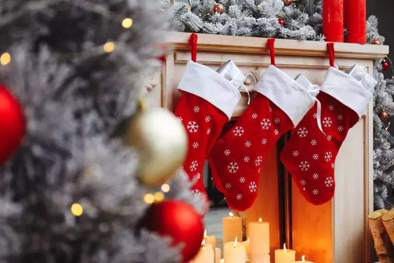 Fireplace with Christmas stockings in festive room interior