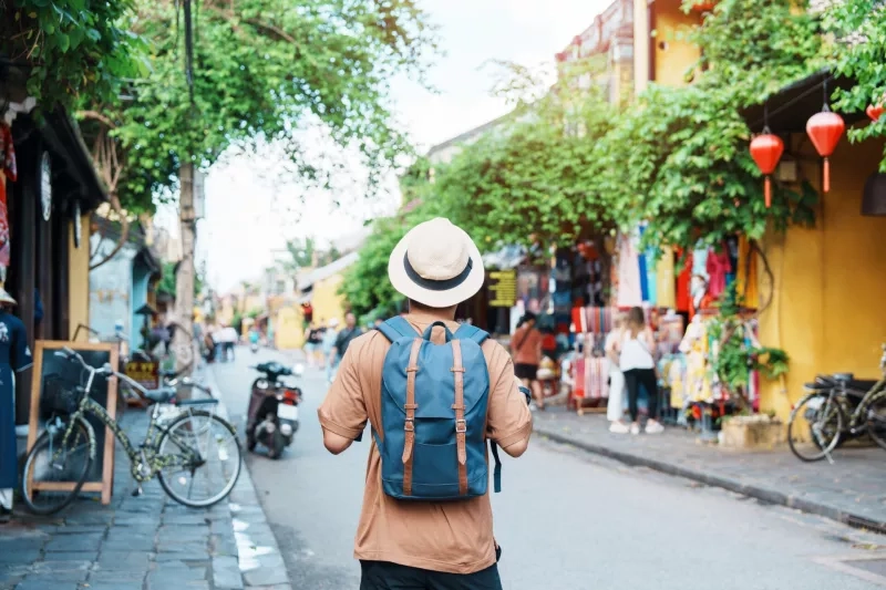 Solo traveler sightseeing at Hoi An ancient town in central Vietnamling with backpack and hat. landmark and popular for tourist attractions. Vietnam